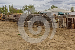 Fence and a house in former port town Moynaq Mo ynoq or Muynak , Uzbekist