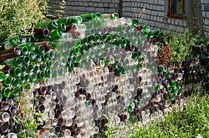 A fence made of empty glass bottles