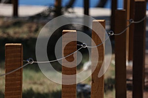 Fence made of wooden poles and metal cables