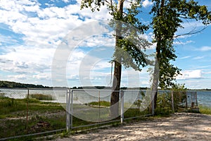 Fence mesh on the lake shore