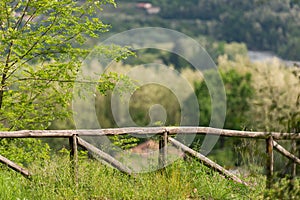 Fence in the mountains made of old tree trunks