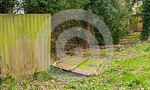 Fence panels blown over by excessive wind during a storm