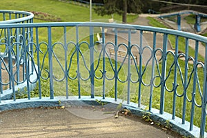 Fence in park. Blue fence. Details of park architecture. Wrought iron