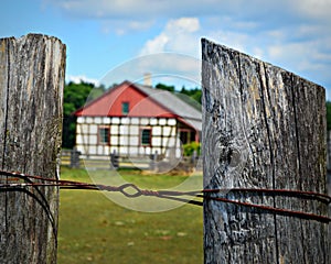 Fence Posts with Historic Building at Old World Wisconsin photo
