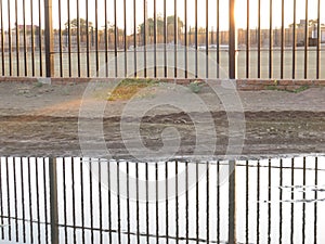 Fence reflecting in water giving a impression of deep water