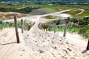 Fence by sand path to dunes