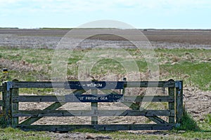 Fence to a nature reserve,Noard-Fryslan Butendyks, Friesland, Holwerd, The Netherlands. A sign with the Dutch text photo