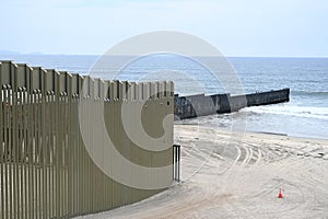 A fence on the United States - Mexico border where it meets the Pacific Ocean in Border Field State Park Beach