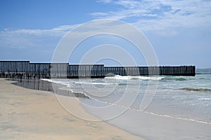 A fence on the United States - Mexico border where it meets the Pacific Ocean in Border Field State Park Beach