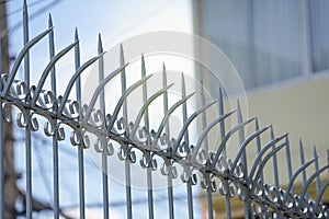 fence in the urban house, strong metal sharp wall fence on top with iron arrow