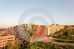 Fence and wall on coast line of sea shore in Malta island