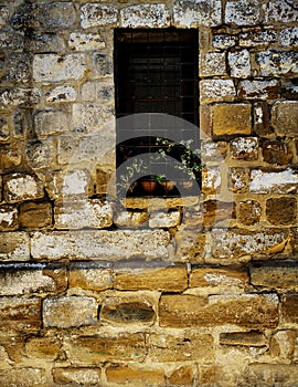 Fence on window in 16th century wall photo