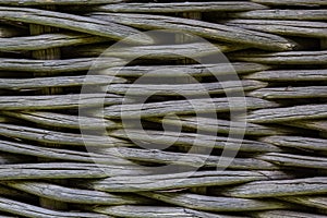 The fence is woven from dry branches, close-up. Weaving from dry willow branches. Wicker willow fence is a traditional wattle