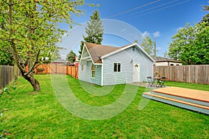 Fenced backyard with small patio area