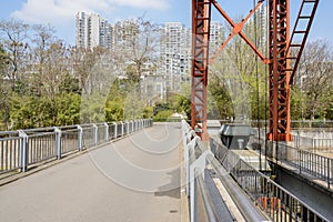 Fenced dam at water gate in city at sunny spring noon