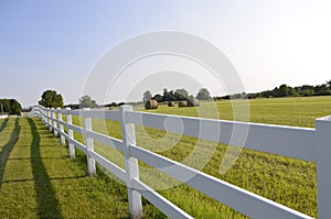 Fenced pastures and rolled hay bales