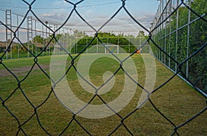 Fenced soccer fiels or handball field with lights