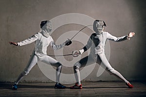 Fencer with fencing sword. Fencers duel concept. photo