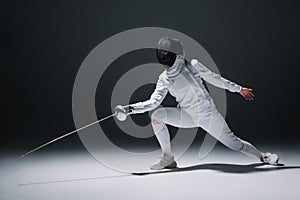 Fencer training under spotlight on black