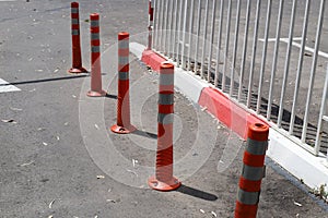 Fencing along the road to separate the carriageway from the sidewalk.