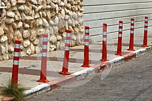 Fencing along the road to separate the carriageway from the sidewalk.