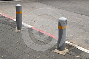 Fencing along the road to separate the carriageway from the sidewalk.