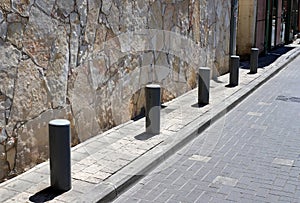 Fencing along the road to separate the carriageway from the sidewalk.