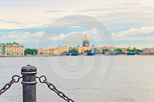 Fencing chain post with blurred background of Neva river, cityscape of Saint Petersburg