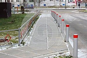 Fencing of the sidewalk from cars several metal posts, antiterrorist protection photo