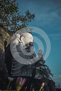 Feng Shui Buddha at Linh Ung Pagoda, Da Nang, Vietnam - Laughing Buddha statue from side view