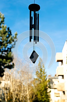 Feng shui chimes with blue sky and house nature in the background