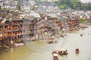 Fenghuang ancient town china and Tuo jiang river tourist boats