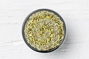 Fennel seed on white wooden background