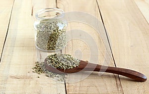 Fennel Seeds Healthy Food on a Wooden Spoon and in Bottle