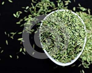 Fennel seeds isolated on a black board in close up