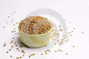 Fenugreek seeds with bowl  on white background