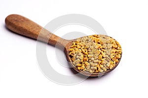 Fenugreek in spoon on white background