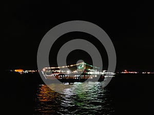 ferie sailing ocean at night with many light on board photo