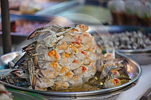 Ferment crab in aluminium trey on street food of Bangkok, Thailand