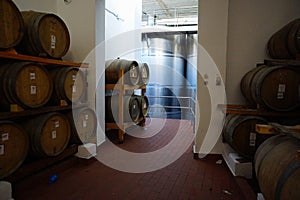 Fermentation tanks and barrels of wine in cellar in Santorini.