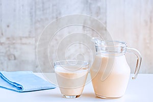 Fermented baked milk in a jug and in a glass.