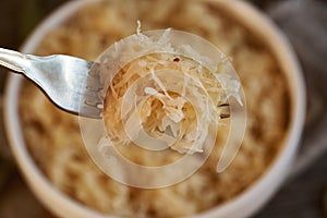 Fermented cabbage or sauerkraut on a fork