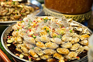 Fermented Crabs with sesame seeds, garlic and chili peper on a vendor stall