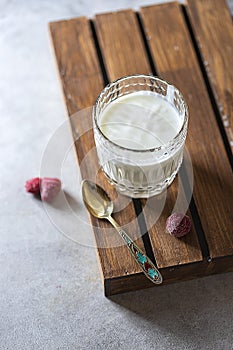 Fermented drink kefir in a glass jar on a light background. Probiotic cold fermented dairy drink