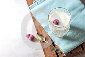 Fermented drink kefir in a glass jar on a light background. Probiotic cold fermented dairy drink