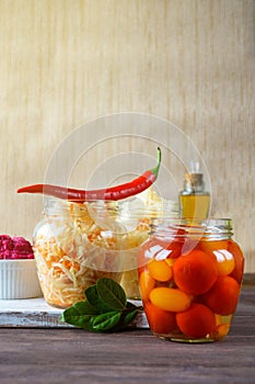 Fermented foods. Sauerkraut, salted tomatoes, pickled plums and spicy horseradish on a white background. Vegetarian food