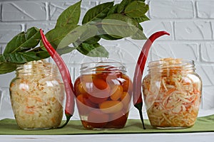 Fermented foods. Sauerkraut, salted tomatoes on a white background. Vegetarian food