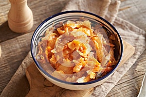 Fermented kim chi in a bowl on a table, top view photo