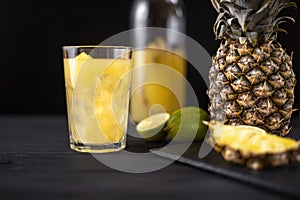 Fermented pineapple lemonade on a black background