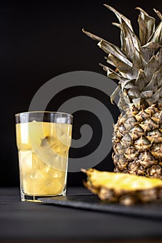 Fermented pineapple lemonade on a black background